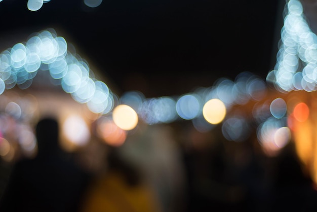 defocused image of illuminated christmas lights at night