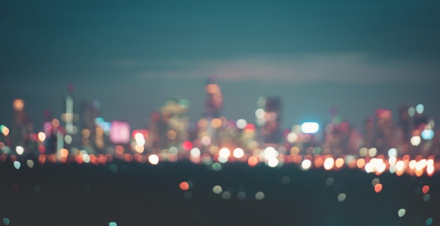 Photo defocused image of illuminated city against sky at night