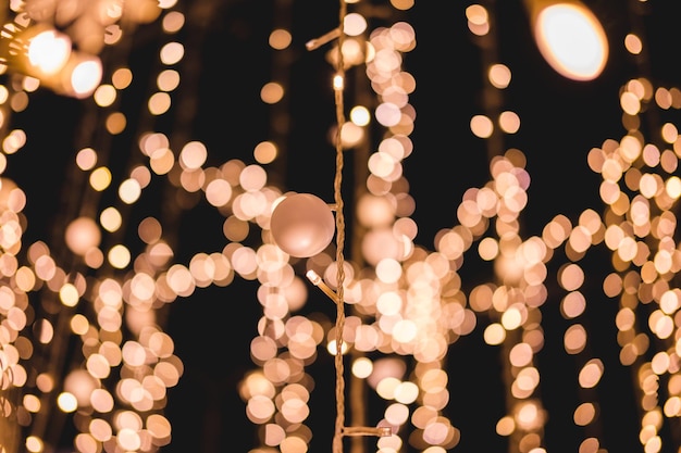 defocused image of illuminated lights hanging at night