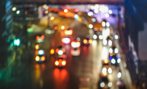 Defocused image of illuminated lights on street at night