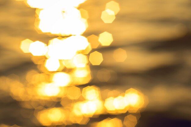 Defocused image of illuminated lights at sunset