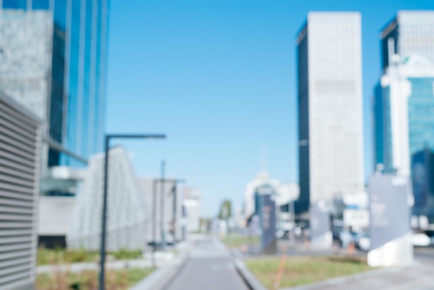 Defocused modern city street skyscrapers and footpath on sunny day outdoors Abstract blurred city