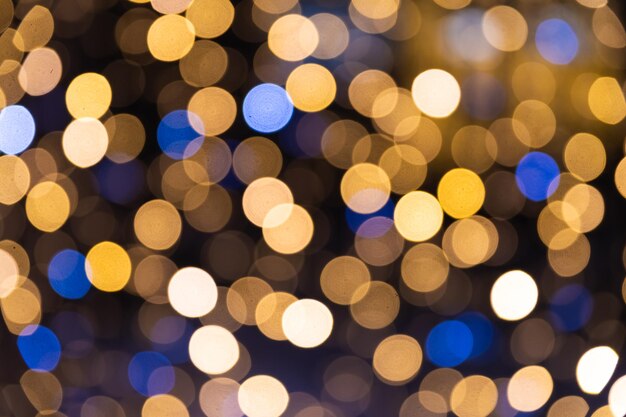 defocused shiny garland lights outdoors winter holiday greeting card