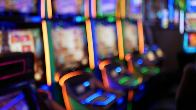 Defocused slot machines glow in casino of las vegas, usa. illuminated neon gambling slots.