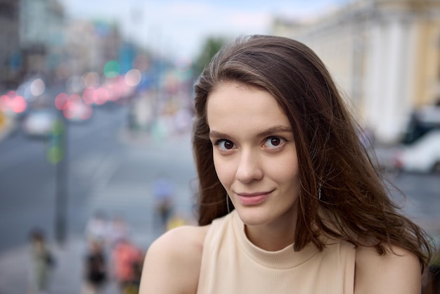 Defocused street in center of large city and woman portrait in front of it