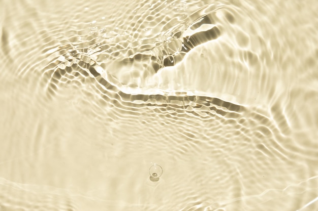 Defocused transparent clear water waves in sunlight Trendy abstract summer nature background