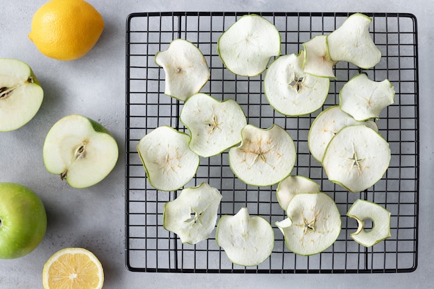 Dehydrated apple chips on cooling rack. Vegan dessert