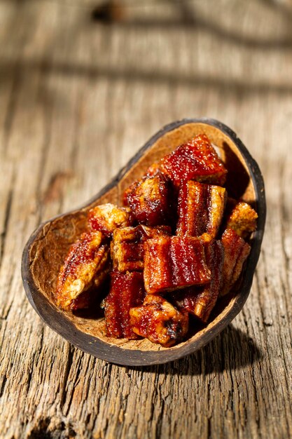 Dehydrated banana on wooden background closeup