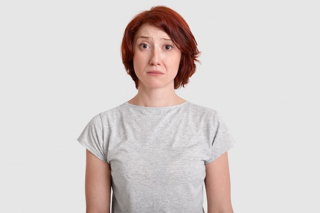 Dejected miserable woman with red hair