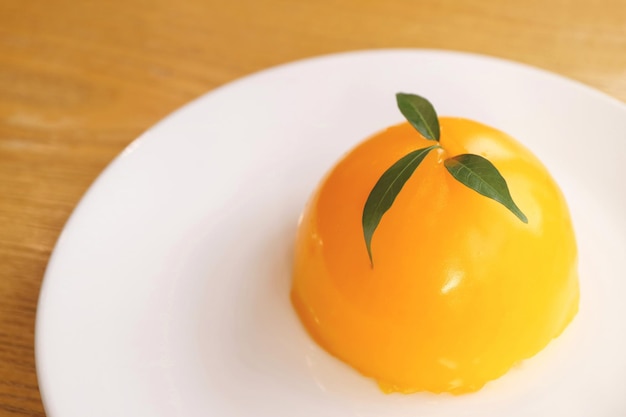 Delectable Mandarin Orange Dome Cake on White Plate with Copy Space