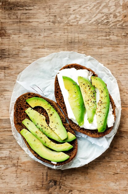 Delectable sandwich with avocado and goat cheese on hearty rye bread