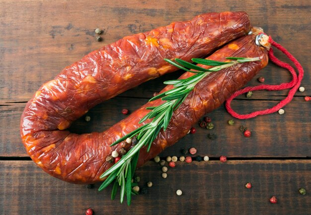 Delicacy smoked sausage salami on a wooden board