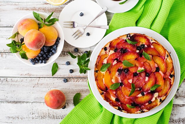 Delicate biscuit pie with peaches and blueberries.