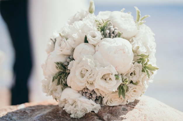 Delicate bouquet of the bride with peonies and roses closeup wedding bouquet bush roses in the bride...