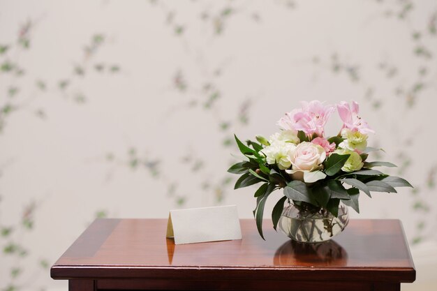 Bouquet delicato in vaso di vetro in interni vintage