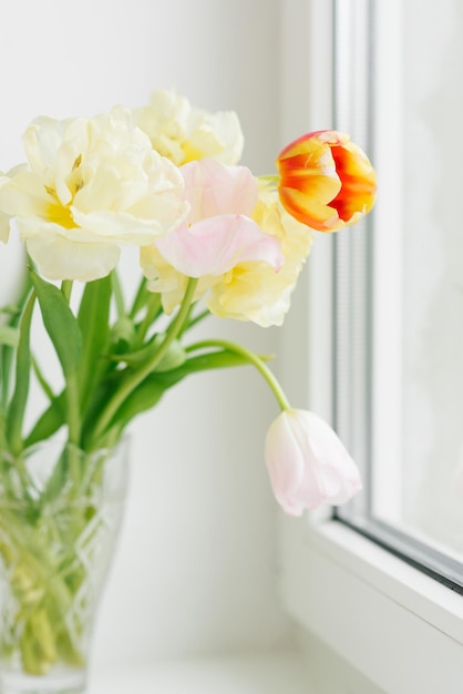 A delicate bouquet of tulips on the window The arrival of spring March 8 Easter Mother's Day Selective Focus