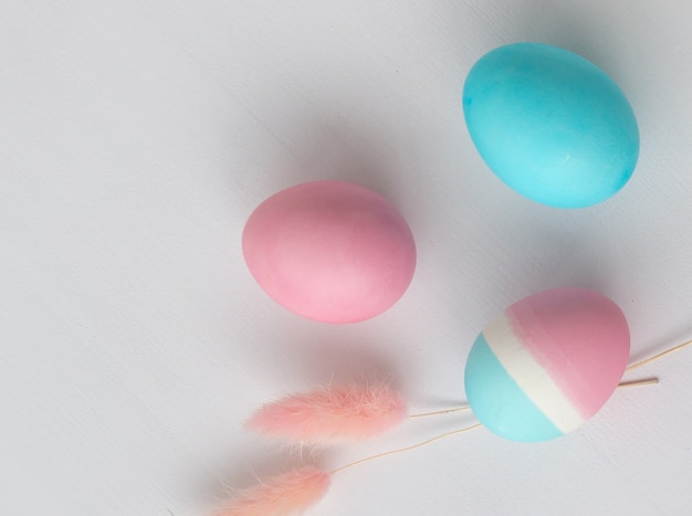 Delicate colors of Easter eggs on a white table, close-up