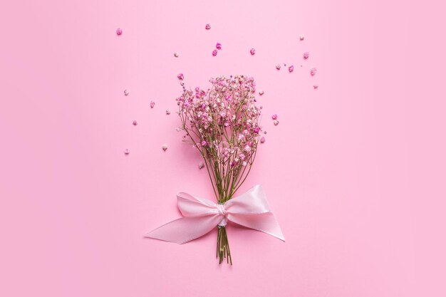 Delicate dry pink flowers Small flowers On a pink background Spring feminine cute Pink background Flowers Dried flowers Empty space Bouquet