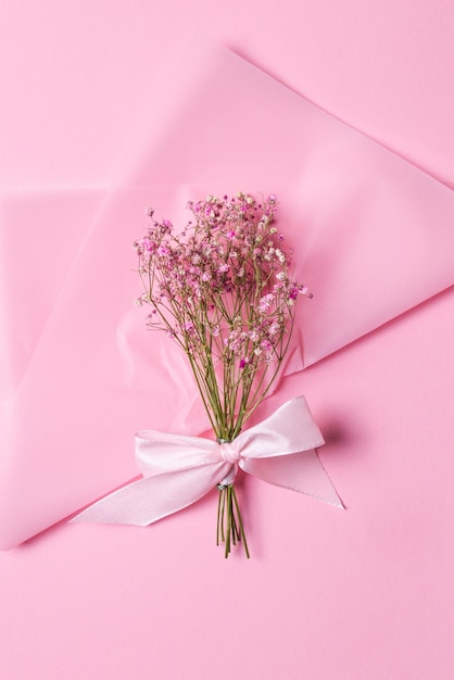 Delicate dry pink flowers Small flowers On a pink background Spring feminine cute Pink background Flowers Dried flowers Empty space Bouquet