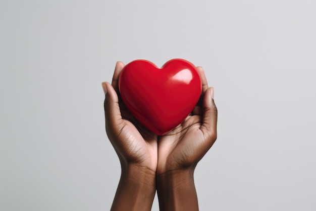 Delicate female hands embrace a scarlet heart embodying care empathy and the fight against AIDS