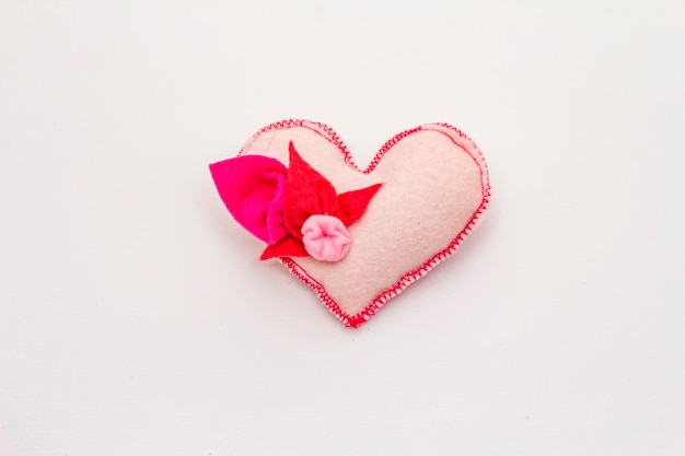 Delicate light pink felt heart isolated on white background. Valentines Day or Wedding romantic concept