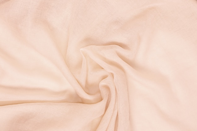 Delicate soft and wrinkled fabric cream color background texture