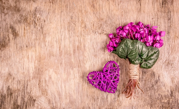 Delicate spring flowers and wicker heart