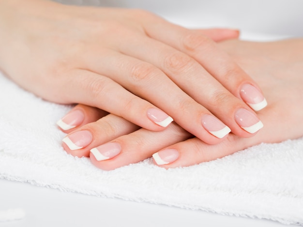 Delicate woman hands on towel