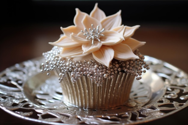 A delicately decorated anniversary cupcake on a shiny silver platter