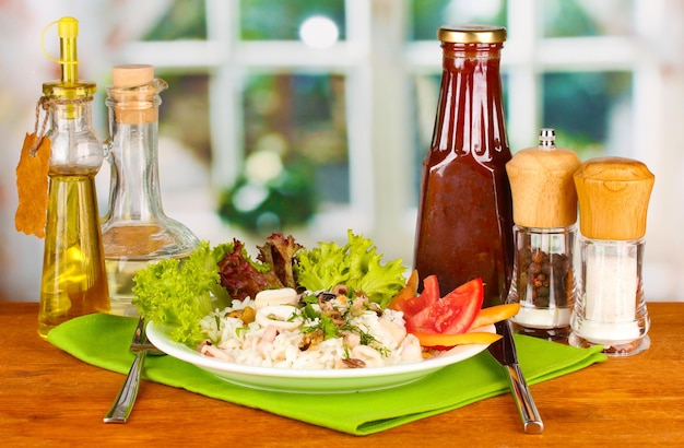 Delicatessen seafood salad with rice on bright background