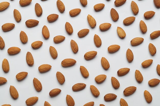 Delicious almonds on white background flat lay