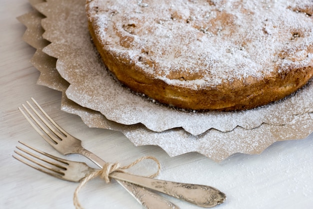 Delicious apple pie for lying on wooden painted table.