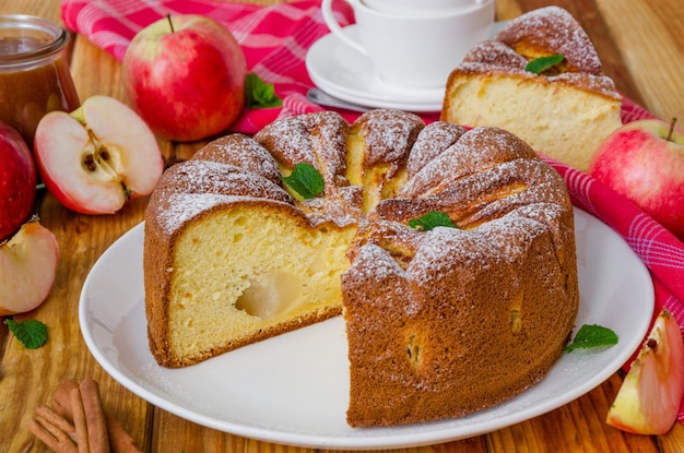 Delicious apple pie with cinnamon and caramel sauce Traditional autumn cake Charlotte