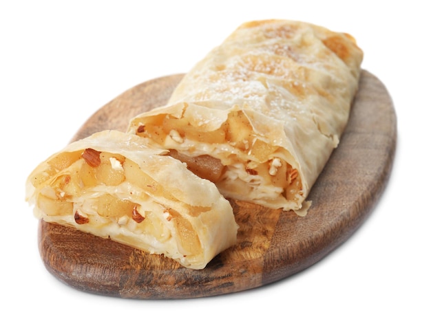 Delicious apple strudel with almonds and powdered sugar isolated on white