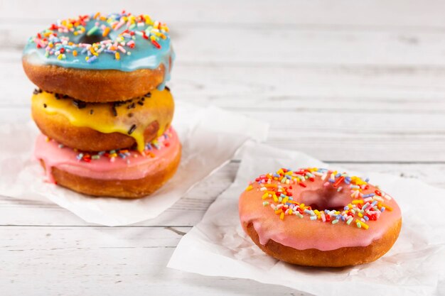 Delicious assorted colorful donuts on the table