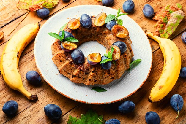 Delicious autumn banana plum cake. Sweet fruit dessert