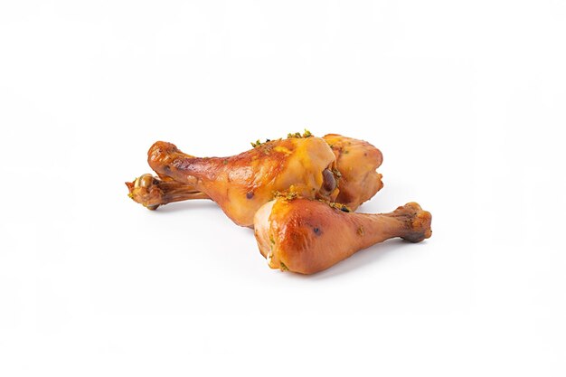 Delicious baked chicken drumsticks in honeymustard marinade isolated on white background