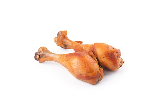 Delicious baked chicken drumsticks in honeymustard marinade isolated on white background