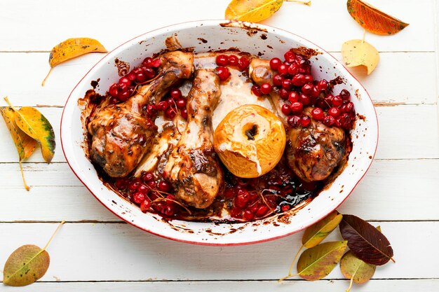 Delicious baked chicken meat with autumn berries in baking dish