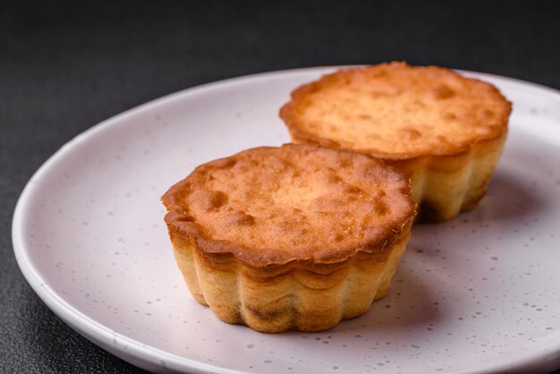 Delicious baked cupcake or tartlet with cheese and raisins