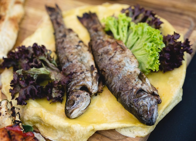 Delicious baked fish with salad