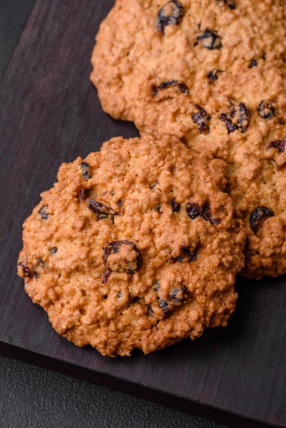 Delicious baked oatmeal raisin cookies on a dark concrete background