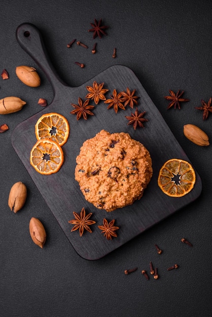 Delicious baked oatmeal raisin cookies on a dark concrete background