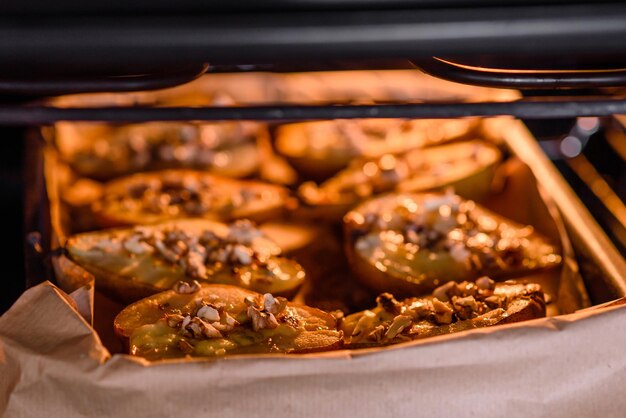 Delicious baked pear with dorblu cheese walnut and honey on a textured concrete background