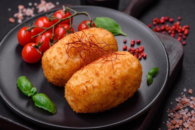 Delicious baked potato cutlet stuffed with chicken and vegetables spices and salt on a dark concrete background