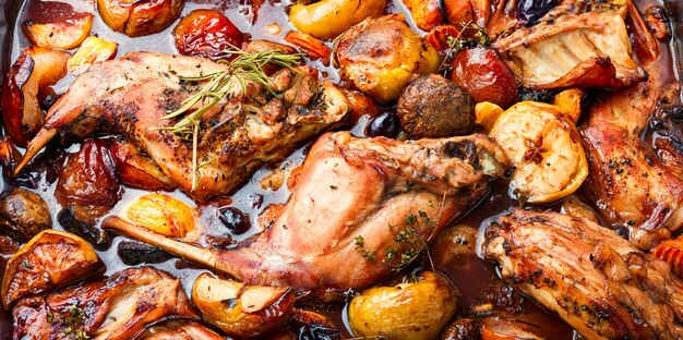 Delicious baked rabbit meat with fruits.Food background,close up