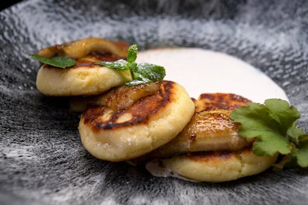 Delicious banana pancakes with sour cream and mint leaves