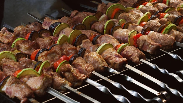 Delicious bbq grilled meat and vegetables on barbecue grill outdoors