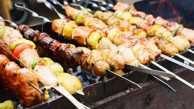 Delicious bbq grilled meat and vegetables on barbecue grill outdoors