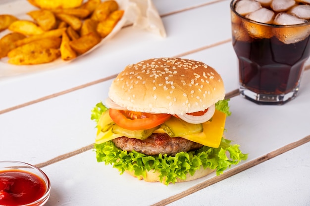 Delicious beef burger with cheese, onion, tomato and lettuce.